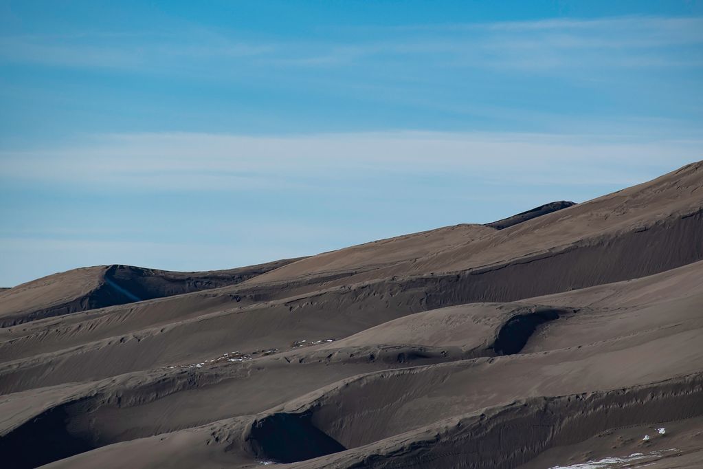 Great sand dune during spring, with snow saying in the shade. 