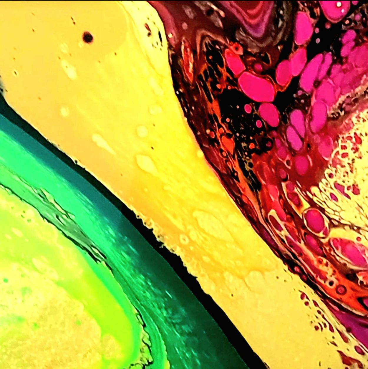 Abstract colorful fluid art with green, yellow, and pink hues.