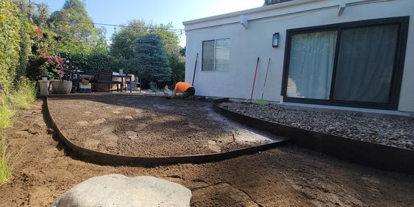 Backyard landscaping with new soil and edging.