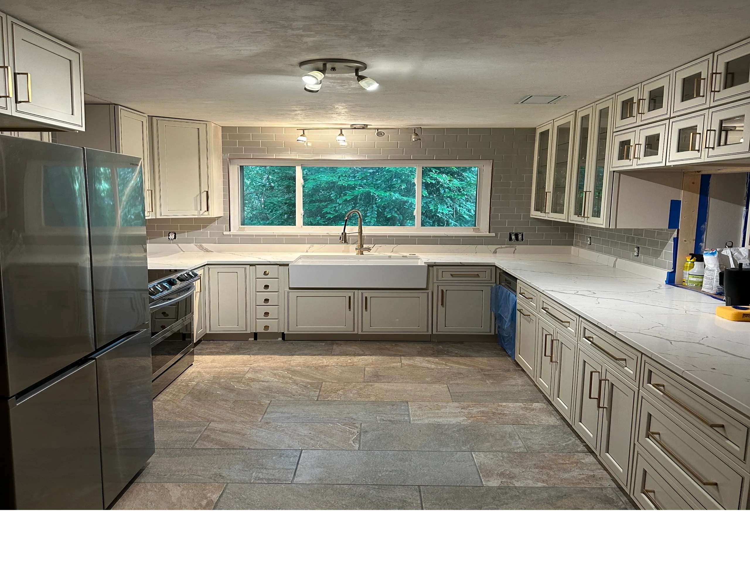Modern kitchen with white cabinets and stainless steel appliances.