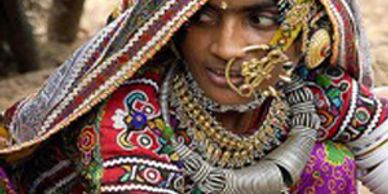 A tribal woman dressed in traditional costume and jewelry in Kutch Gujarat