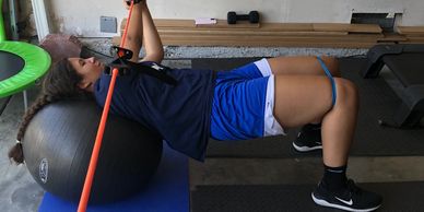 Sports performance training on a swissball, girls basketball, strength.