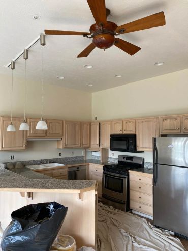 Modern kitchen with wooden cabinets and stainless steel appliances.
