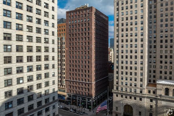 Brown Office Building surrounded by other tall office buildings 