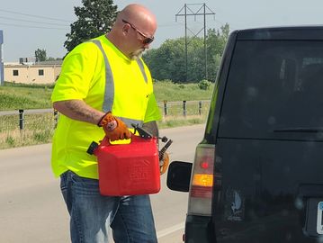 Man putting gas in vehicle