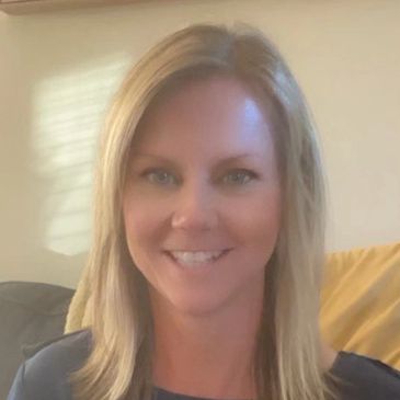 Smiling woman sitting on a couch.