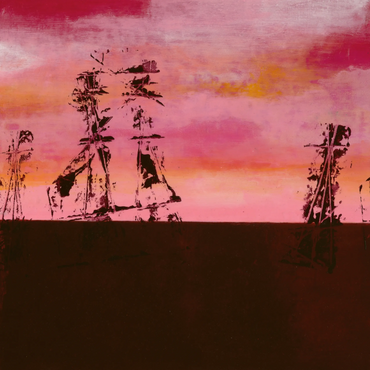 Silhouettes of ships against a vivid pink and orange sunset.