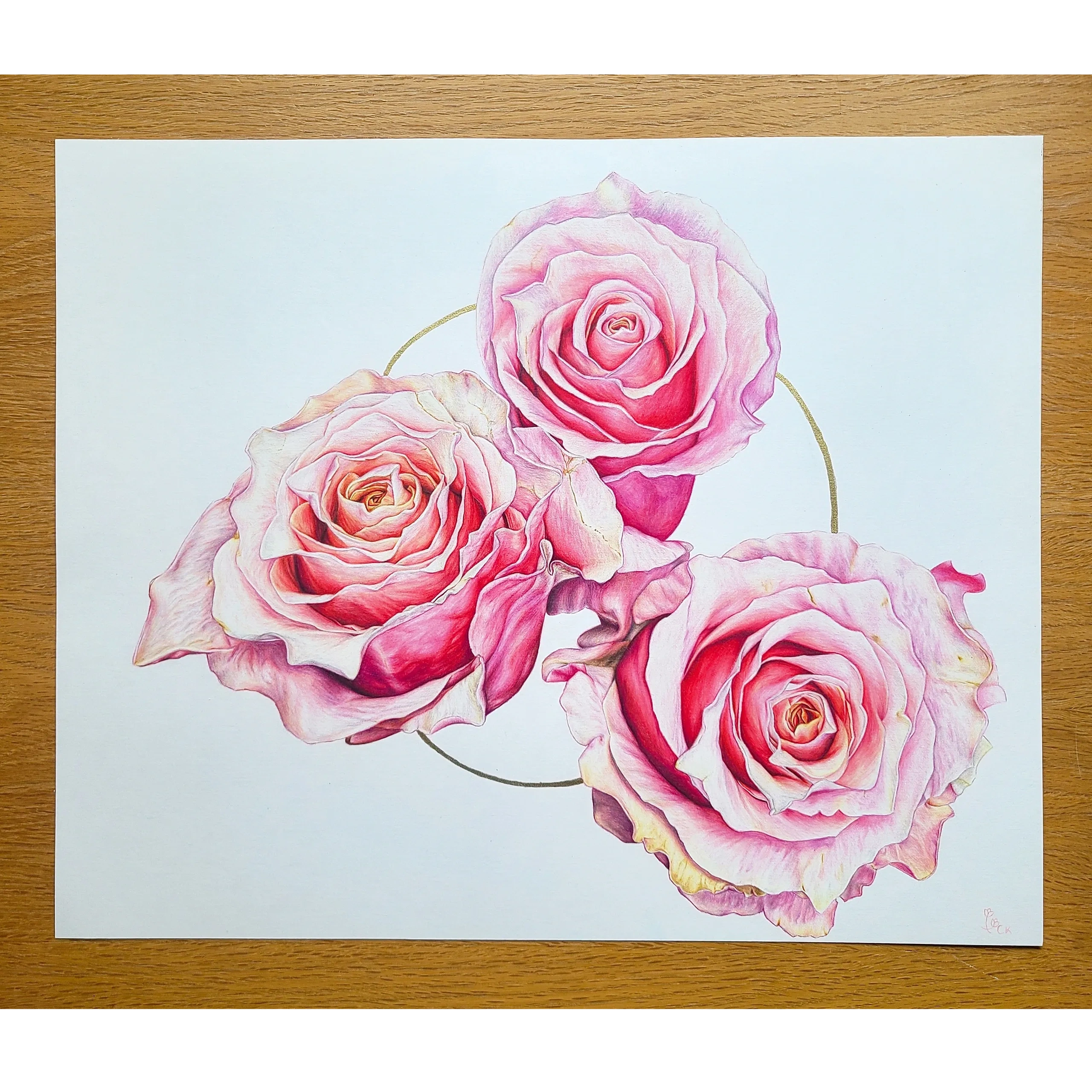 Three pink roses with a gold circle on a white background.