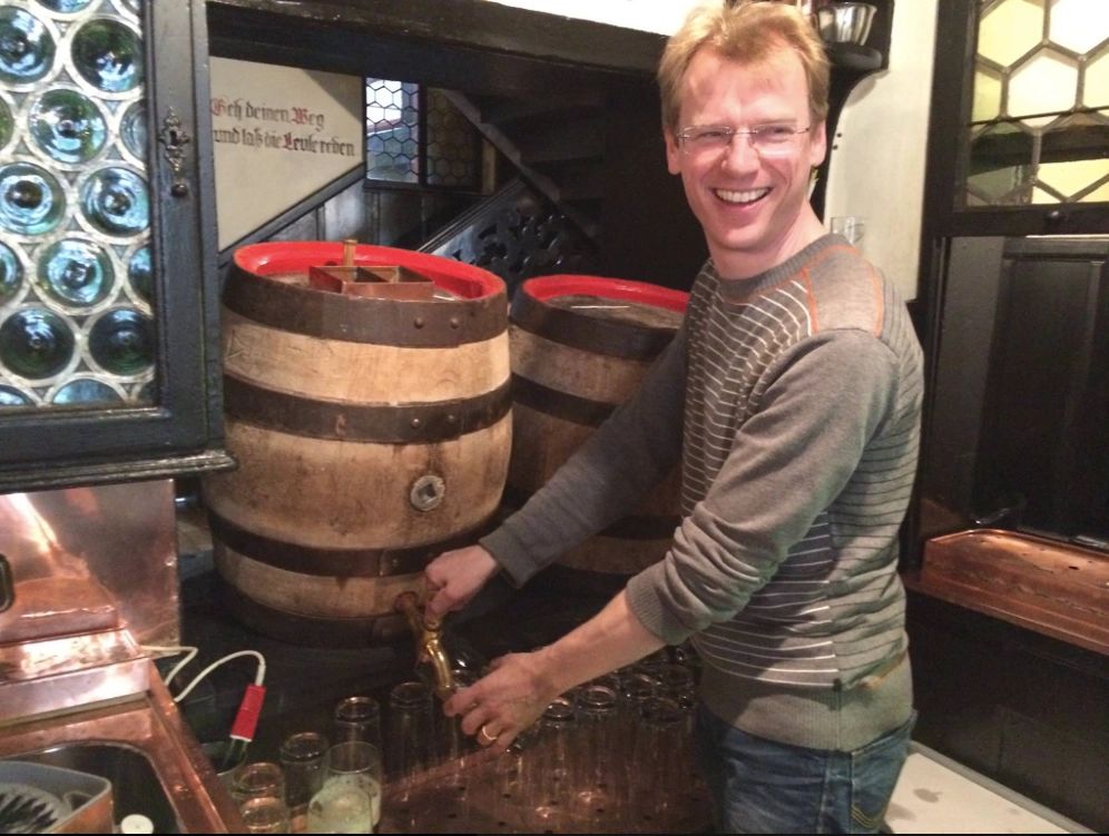 Schlenkerla brewemaster Matthias Turm pouring rauchbier from one of the brewery's signature oakwood kegs. 