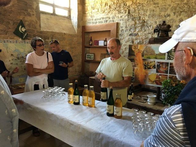 Bernard Lebrec offering cider to guests at his farmhouse distillery. 