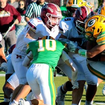 High school football players in action.