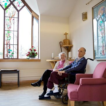 An older couple sitting in a stylish church