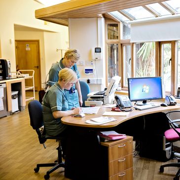 Hospice nurses at their open plan office desk