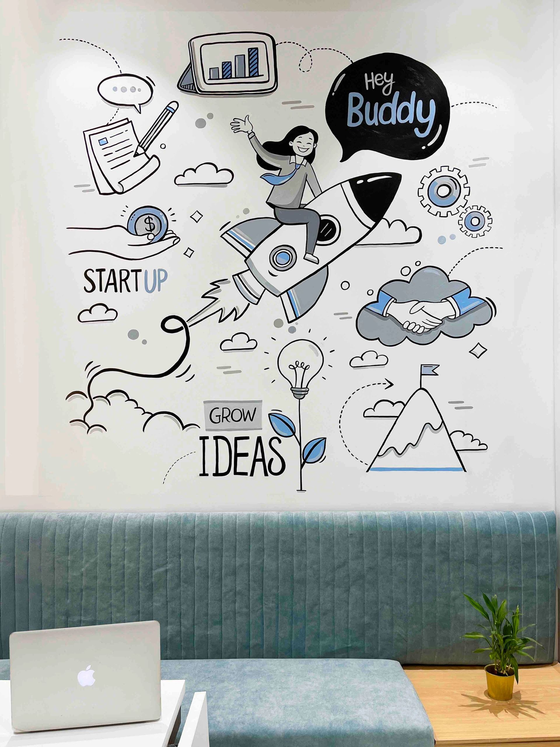 Wall art featuring startup and growth ideas with a rocket and business symbols.