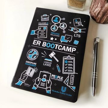 Black ER Bootcamp notebook with HR-related icons and a silver pen.