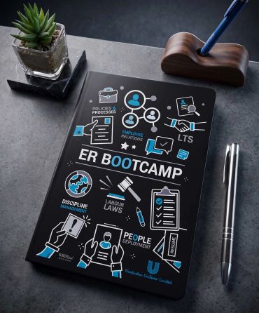 A notebook titled 'ER Bootcamp' with HR-related icons on a desk.