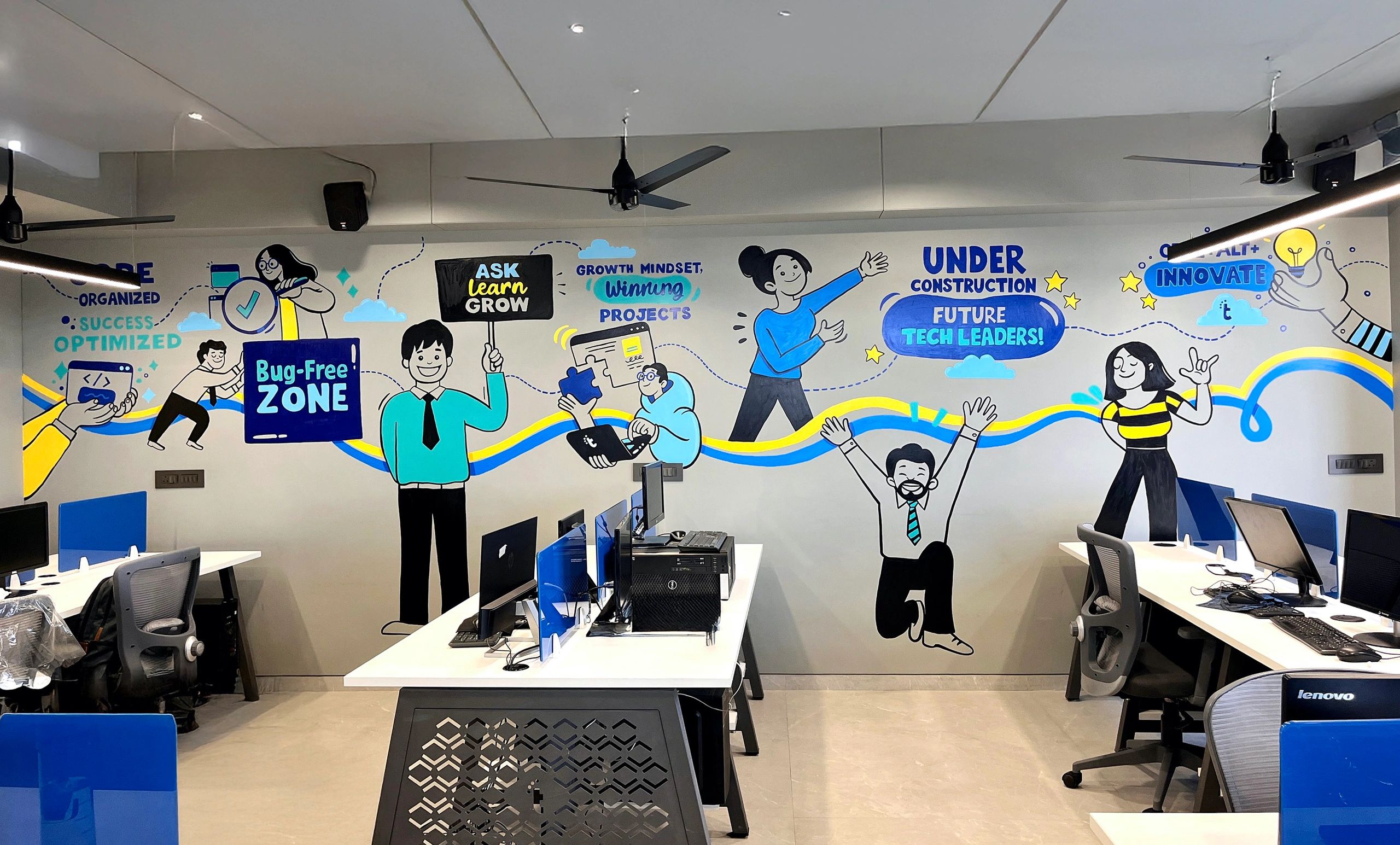 Colorful office wall mural promoting growth mindset and tech innovation.