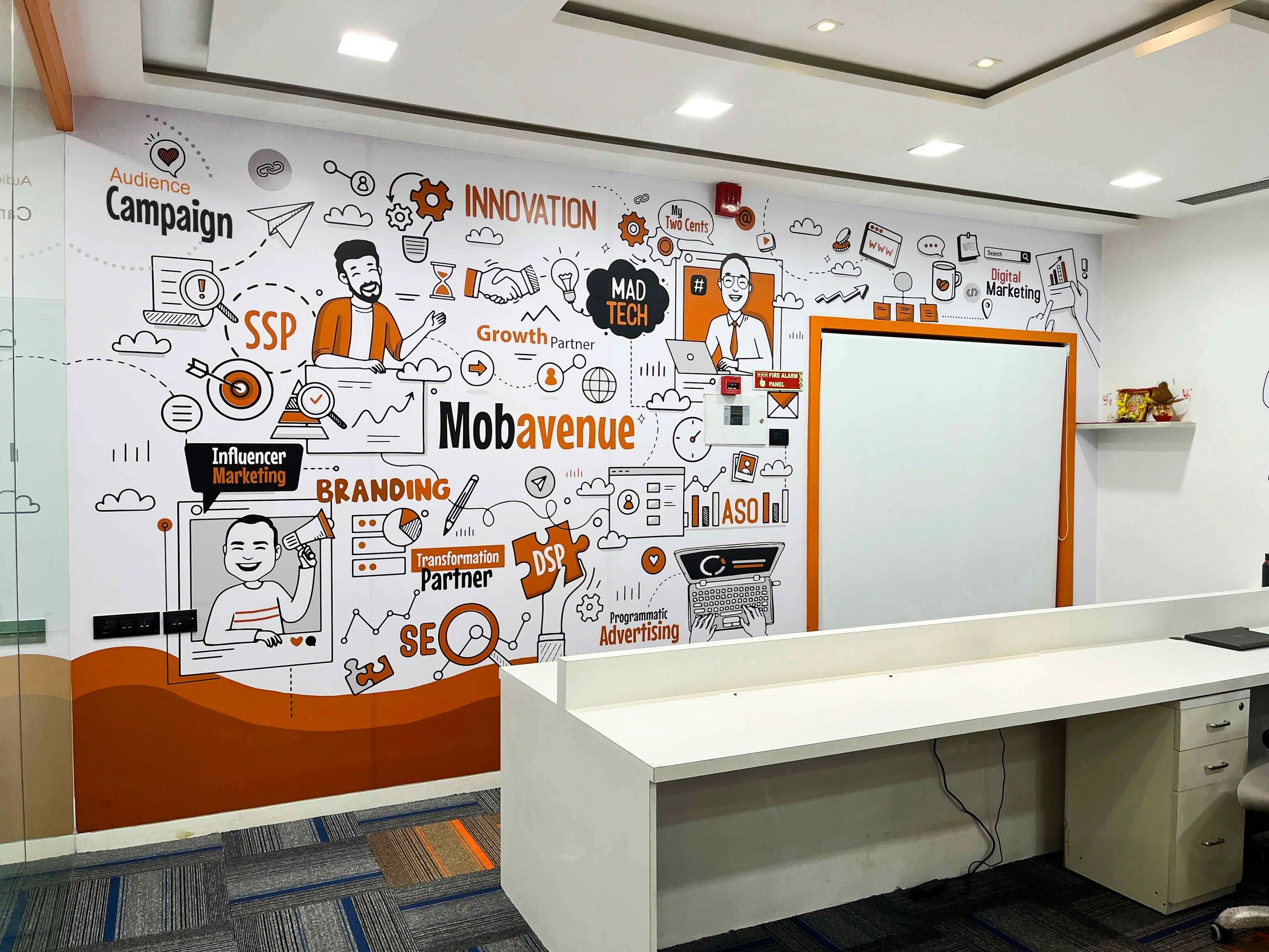 Modern office wall with colorful digital marketing and innovation illustrations.