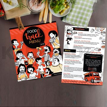Colorful food truck menu with cartoon characters and dish listings on a wooden table.