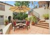 Outdoor dining and staircase leading to deck over new family room