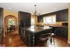 Custom cabinets, "hide" the SubZero refrigerator and dishwasher. Black Amazon Forest Granite counter tops