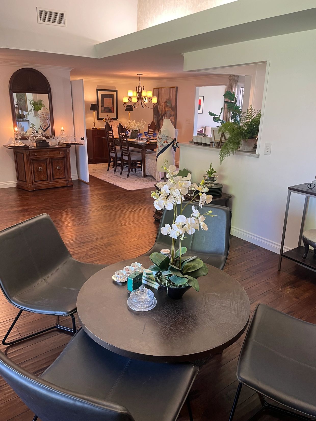 Cozy dining area with modern chairs and a floral centerpiece.