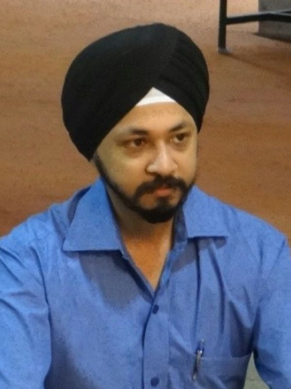 Man wearing a black turban and blue shirt.