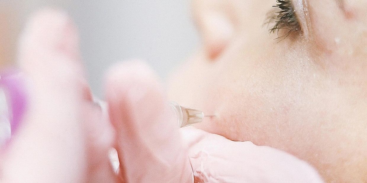 Close-up of a facial injection procedure.