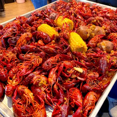 Tray of cooked crawfish with corn and potatoes.