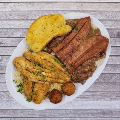 Plate with blackened fish, sausage, rice, beans, toast, and hush puppies.