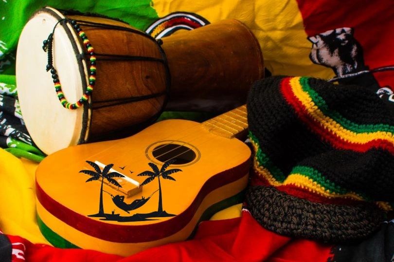 Image showing a guitar, a hat wuth stripe colours of green, red, yellow and black and a bonjo drum.