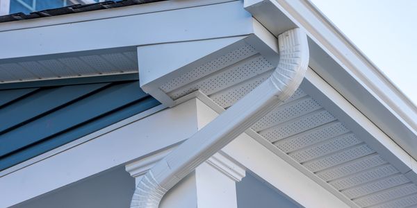 Clean white porch soffits after the soft wash house cleaning service.