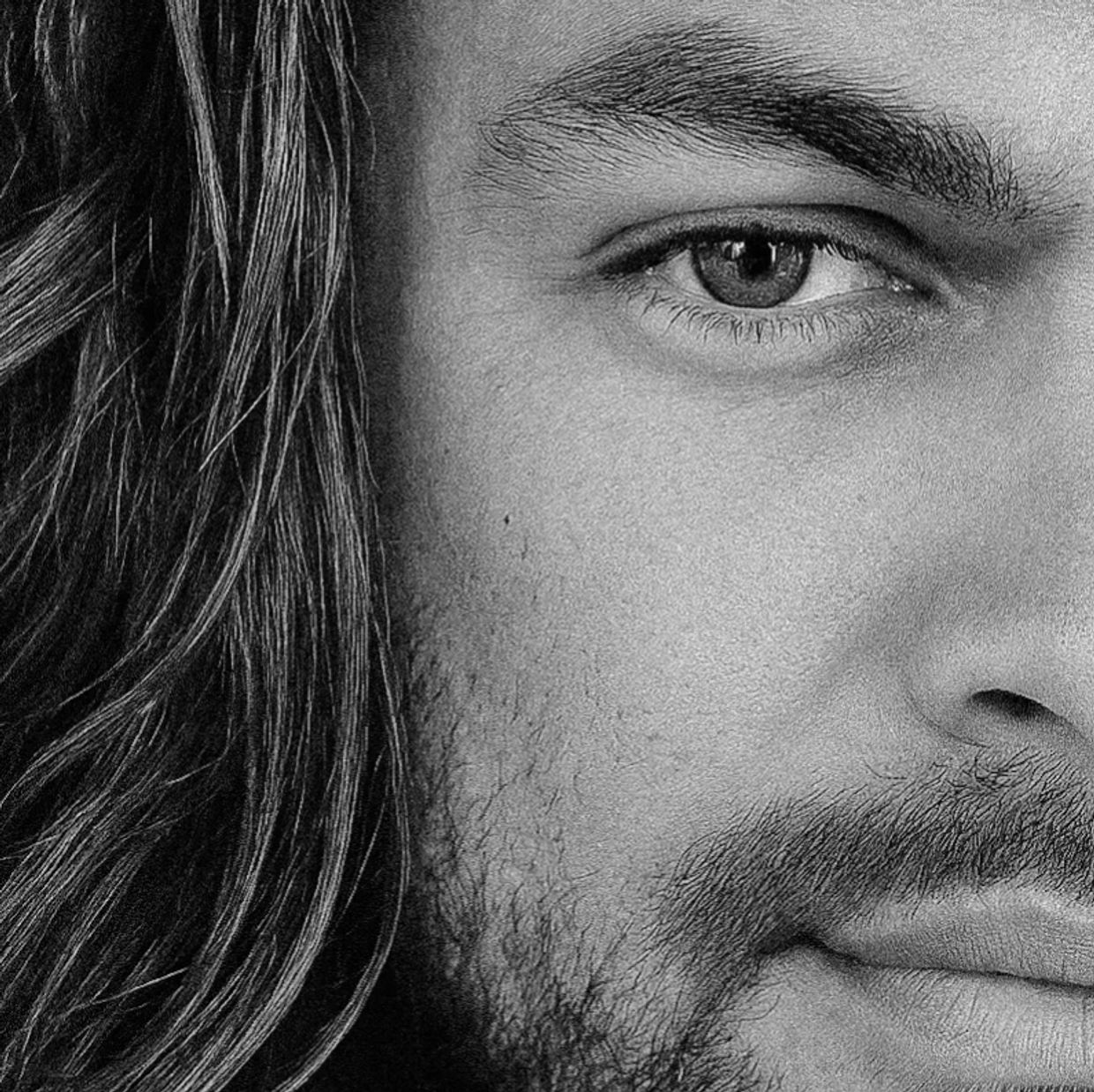 Close-up of a man's eye and facial hair.