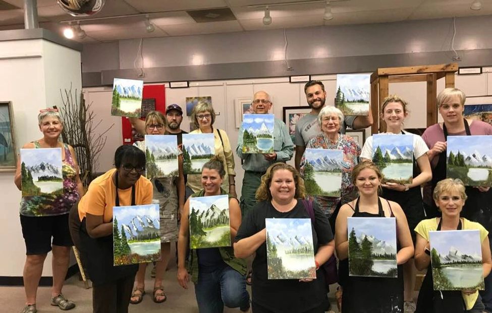 A workshop group showing off their finished paintings!