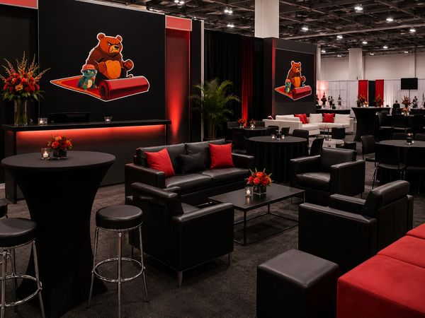 A stylish lounge area with black furniture and red accents.