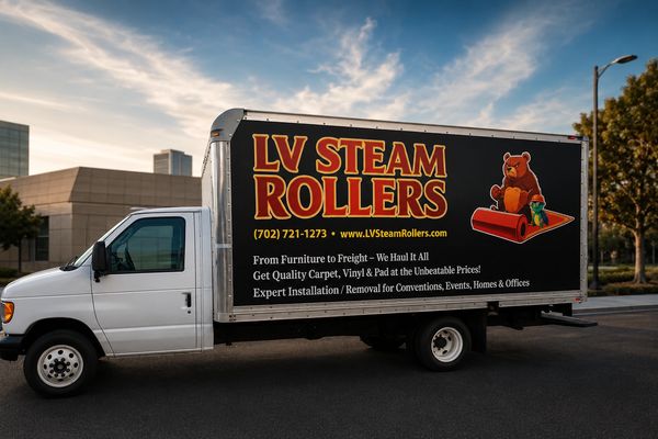 A white truck with LV Steam Rollers advertisement showcasing carpet and flooring services.
