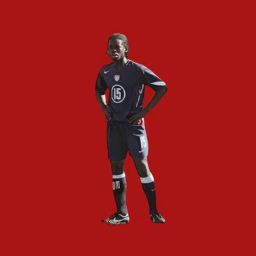 Soccer player in number 15 jersey standing with hands on hips.