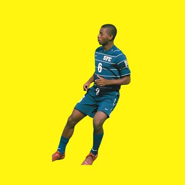 Soccer player in blue kit against yellow background.