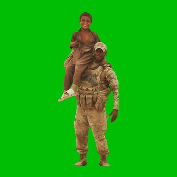 Soldier carrying smiling child on shoulder.