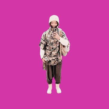 Man taking selfie against purple background.