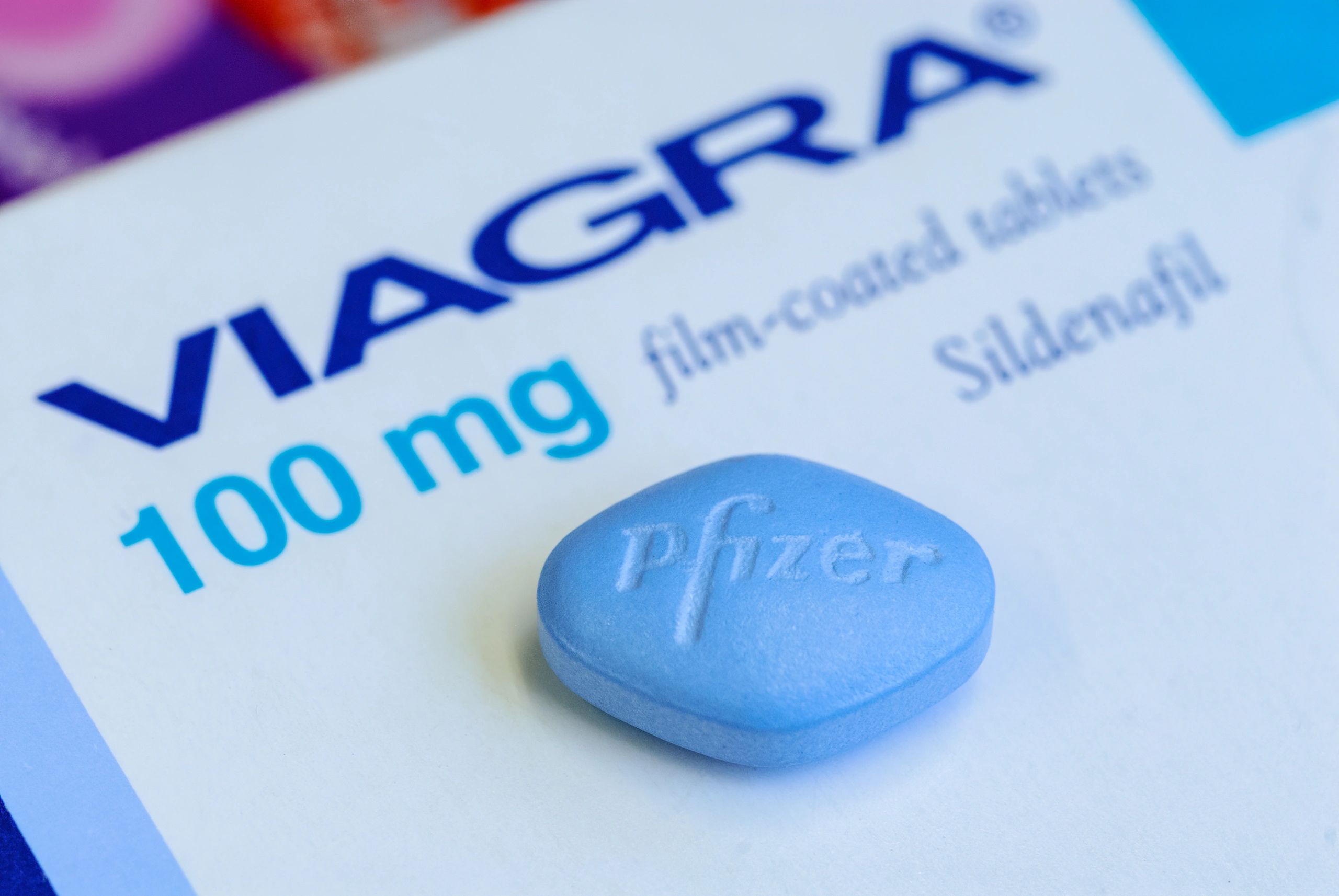 Close-up of a blue Viagra pill on its packaging.