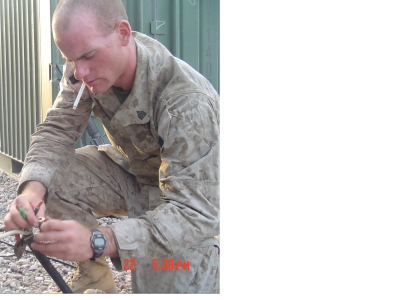 Soldier smoking and working with equipment.