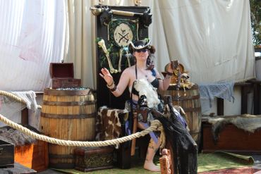 Person in Viking costume posing with props.