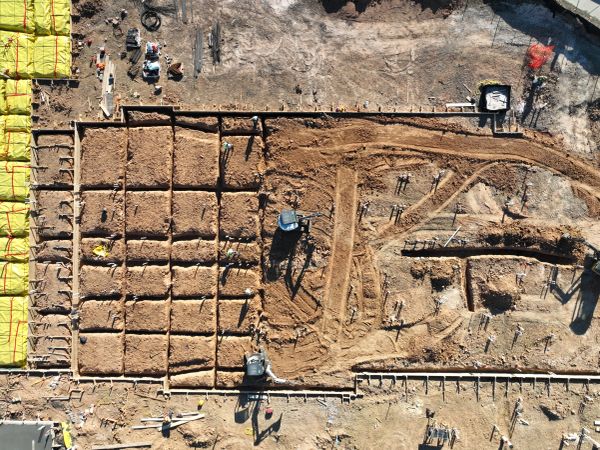 Aerial view of construction site with dirt and equipment.