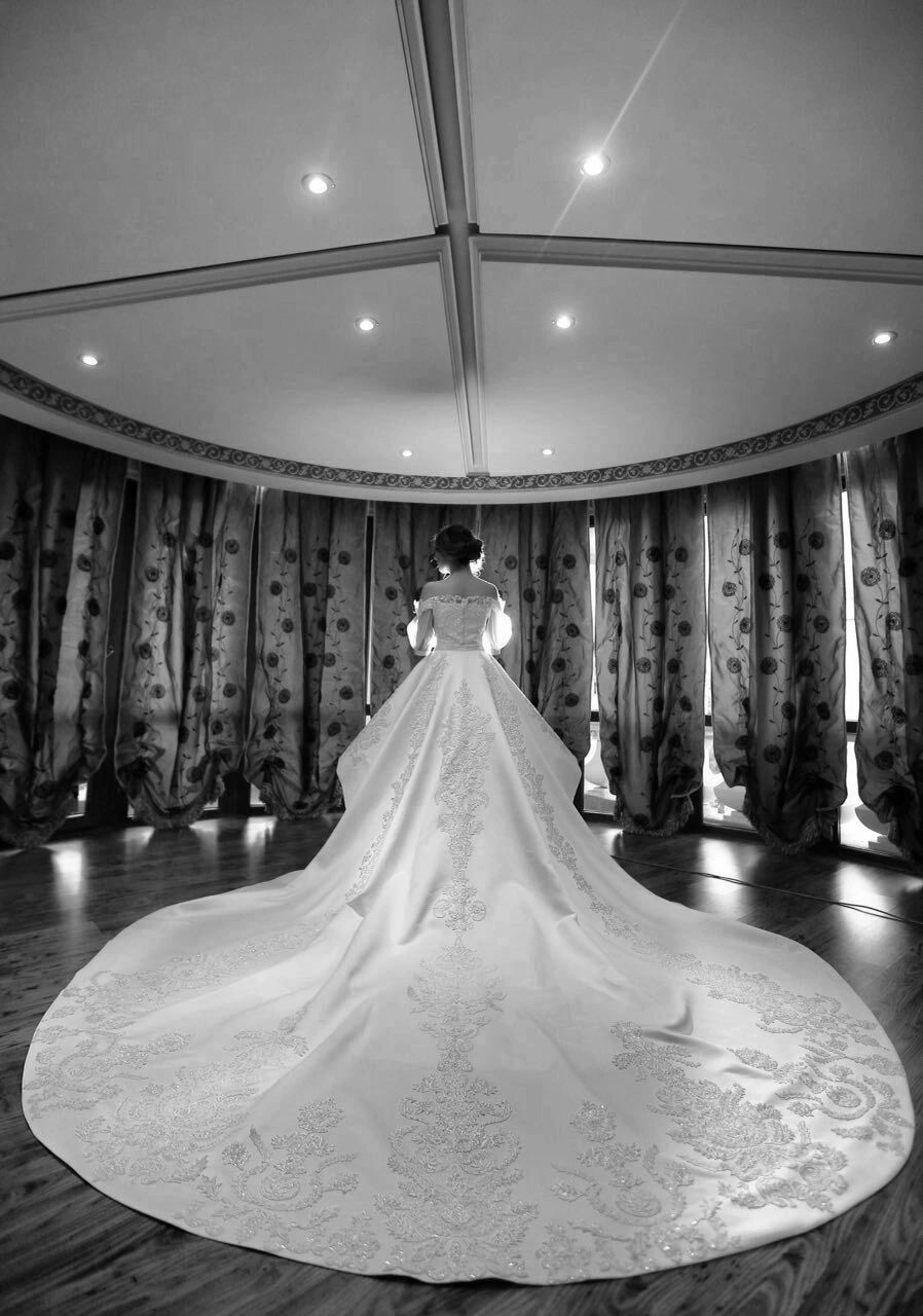 Back view of our custom satin wedding gown (2013), with lace hand-placed and redesigned to follow th