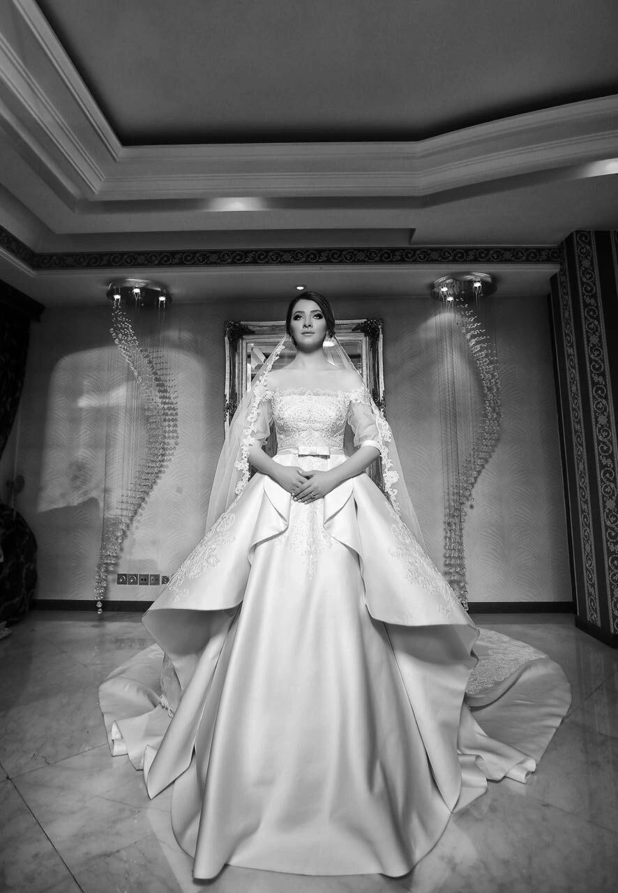 Designed and made for our bride: a satin ball gown with a lace appliqué bodice, sheer lace sleeves a