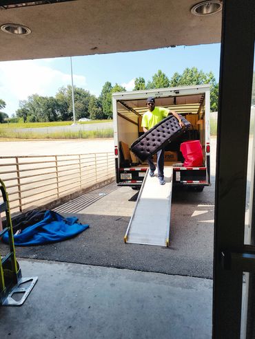Mover unloading footboard at U-Haul storage in Atlanta, GA. 
