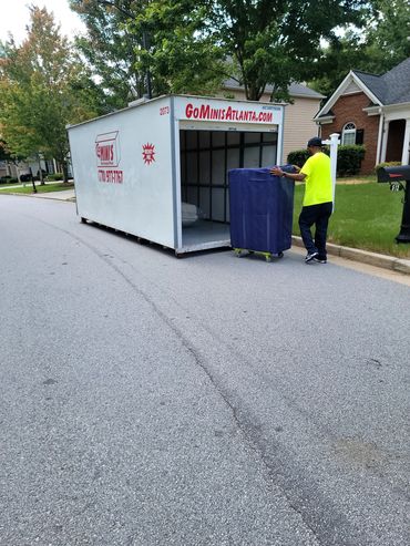 Mover from Grab And Go Movers loading a Go Mini Atlanta storage pod in Mableton, GA.
