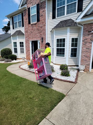 Cheap movers in Atlanta Ga carrying doll house into new home in Douglasville Ga