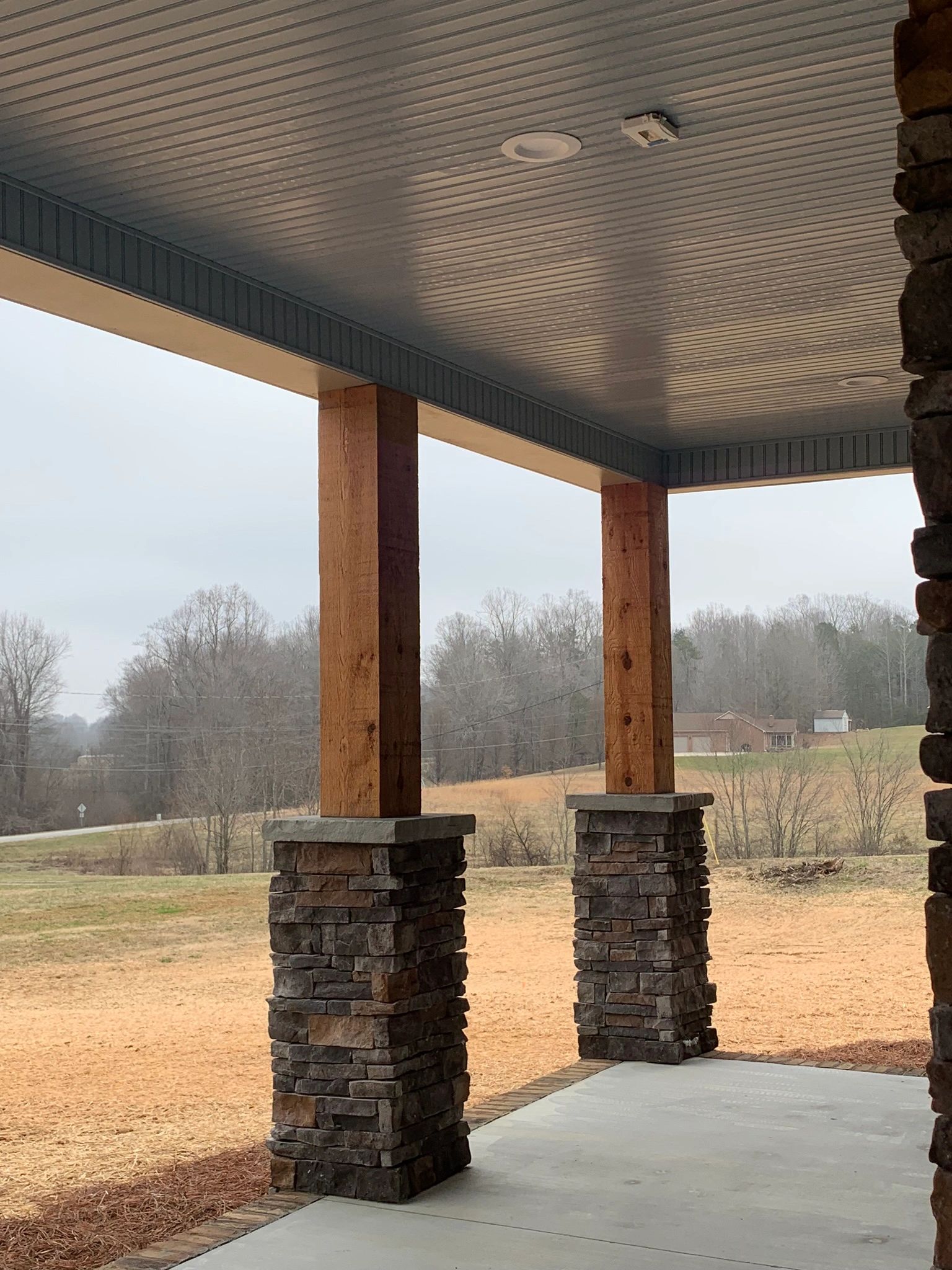 Gorgeous Savannah Blue ceiling on this inviting front porch on this custom stick built home!